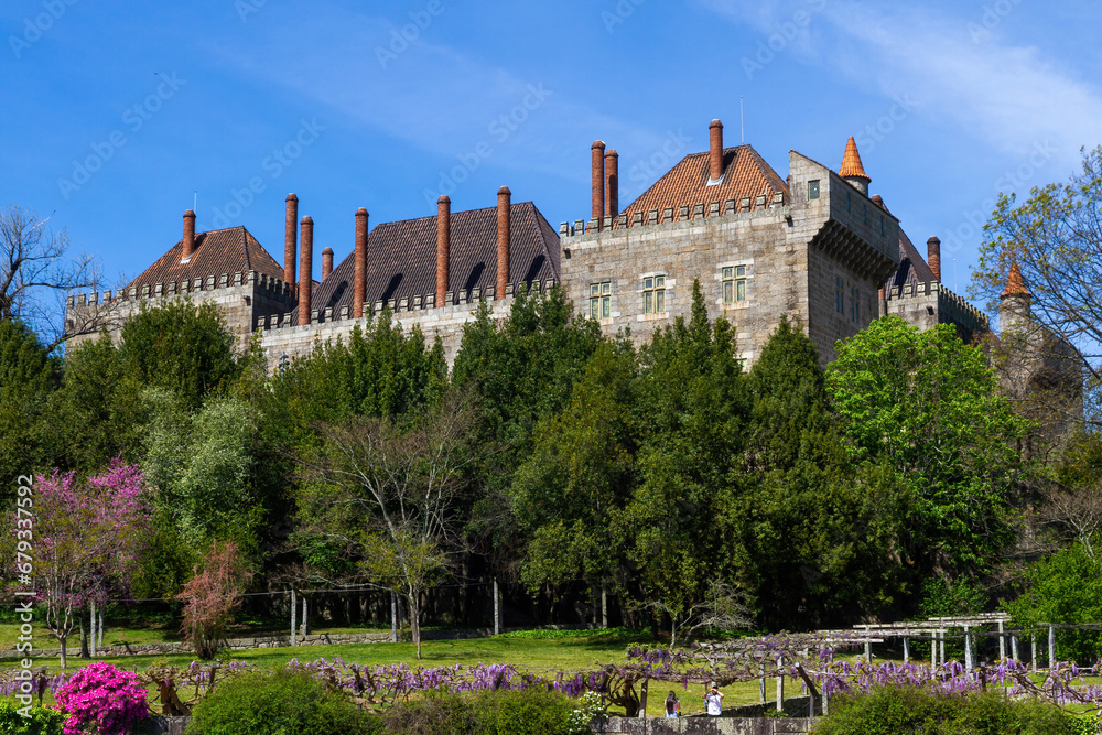 Palace of the Dukes of Braganza surrounded by vegetation in Spring, Guimarães, Portugal