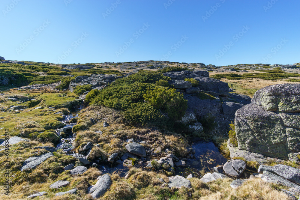 Beautiful rocky landscape of high plateau of Torre with small mountain creek little vegetation on sunny autumn day, Torre, Serra da Estrela, Portugal Beautiful rocky landscape of high plateau of Torre with small mountain creek little vegetation on sunny autumn day, Torre, Serra da Estrela, Portugal