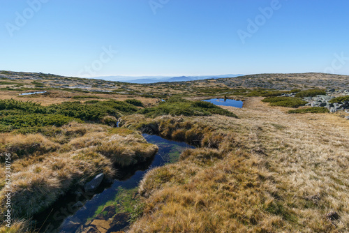 Beautiful rocky landscape of high plateau of Torre with small mountain creek little vegetation on sunny autumn day, Torre, Serra da Estrela, Portugal