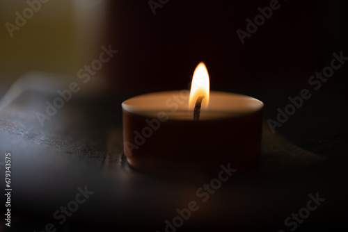 Small candle on dark background