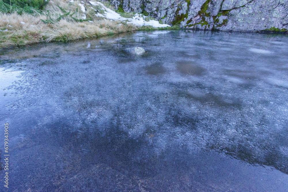 Abstract background of bubbles of air under layer ice in clear water lake Abstract background of bubbles of air under layer ice in clear water lake