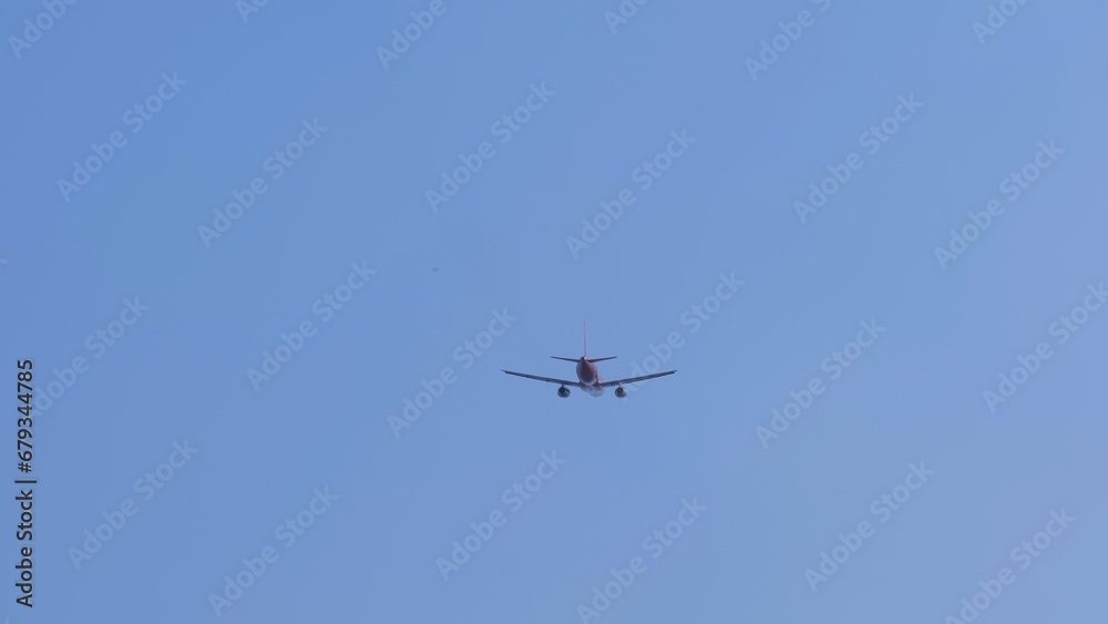 Airliner with passengers on the blue sky. The plane flies in the sky. The plane takes off against a clear sky. Airliner with passengers on the blue sky. The plane flies in the sky. The plane takes off against a clear sky.