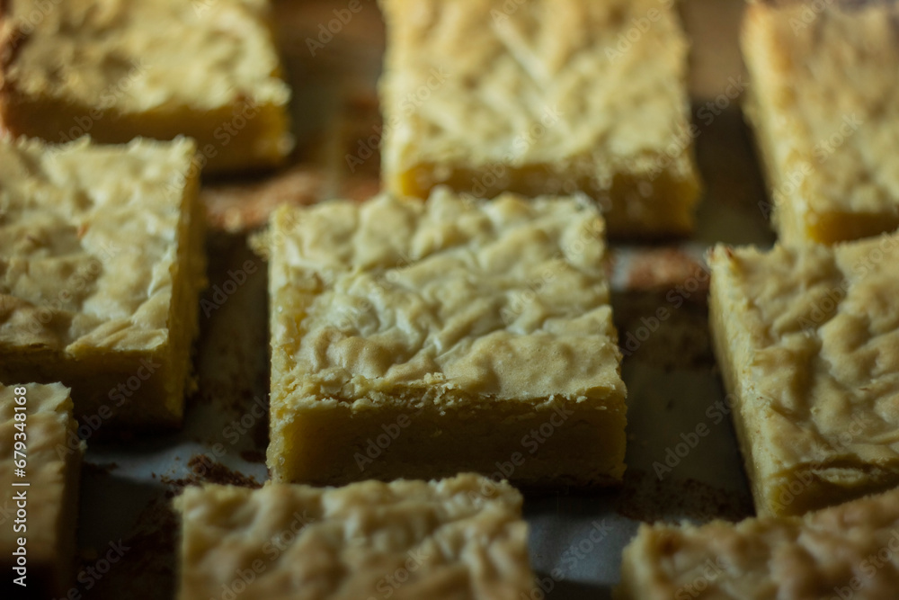 Detail of a piece of a delicious white chocolate brownie straight out of the oven. Detail of a piece of a delicious white chocolate brownie straight out of the oven.