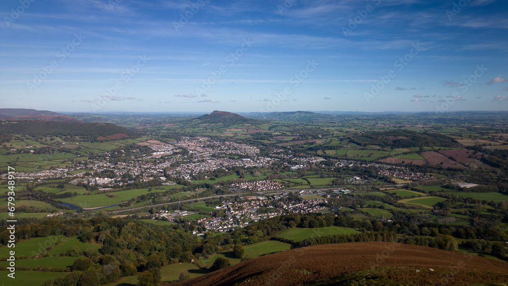 Skyline with Skirrid Fawr mountain around Abergavenny town in the Brecon Beacons Black Mountains national park. Blue sky above picturesque rugged natural beauty in Bannau Brycheiniog South Wales