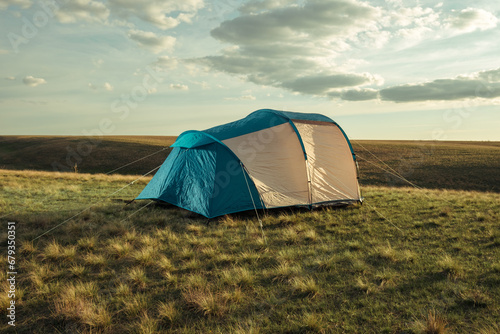 Tent in the steppe against the backdrop of the sunset