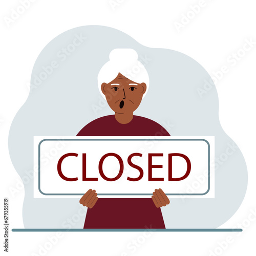 A woman holds a sign with the text Closed in his hands.