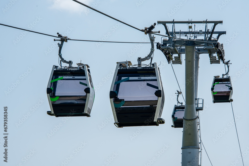 Cable Car in landscape park. Transport tourists uphill, cableway cabins. Ropeway, aerial lift
