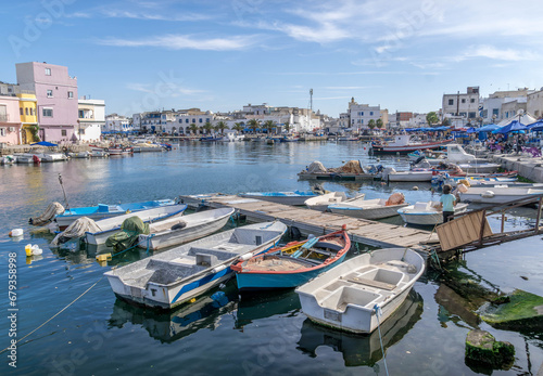 The boats and piers are at the Bizerte port harbor on the Mediterranean sea, with the houses along the promenade at north of Tunisia. © Artaxerxes