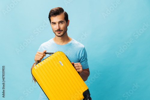 Man guy journey suitcase weekend trip traveler baggage vacation travel background yellow happy studio flight