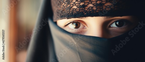 Charming Muslim teenage girl eyes in a black niqab photo