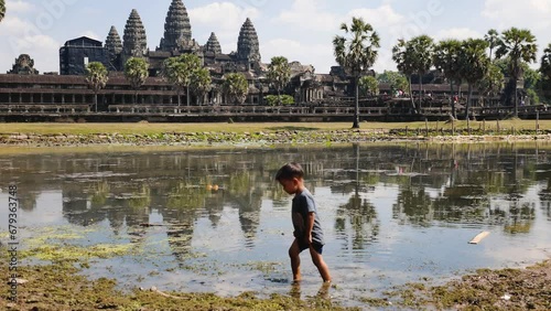 Child plays in front of the Angkor Wat temple in Cambodia