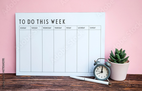 Weekly planner on pink background . To do this week  photo