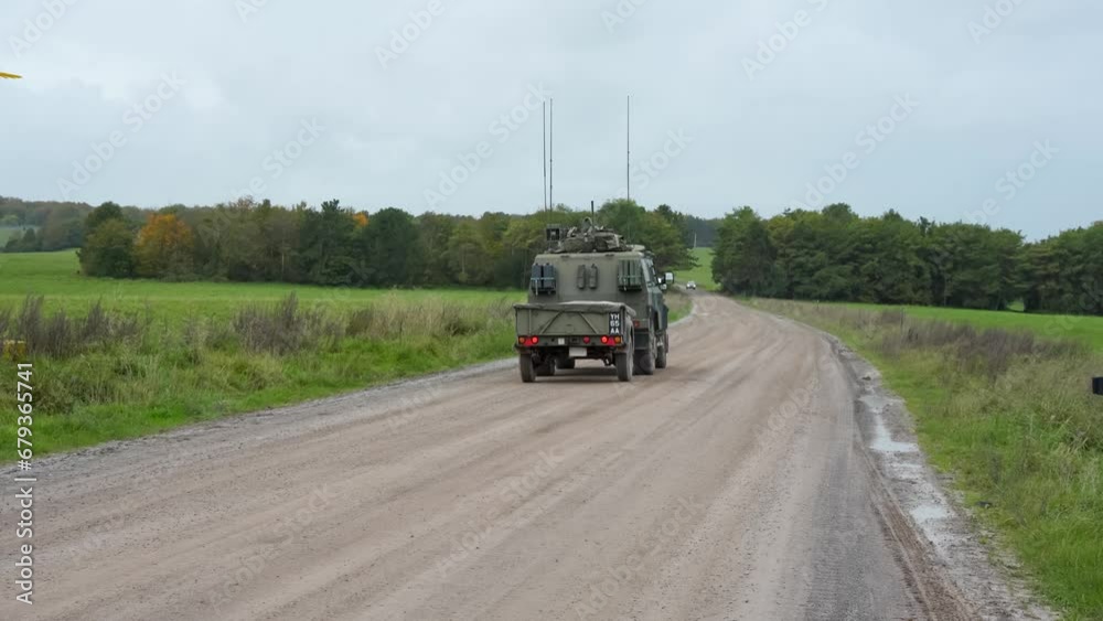British army Panther with trailer driving on a dirt track. Wilts UK British army Panther with trailer driving on a dirt track. Wilts UK
