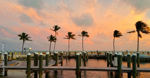 Wooden piers fit perfectly into the relaxing atmosphere of a picturesque sunset in a tropical paradise. Florida Kays, USA. photo