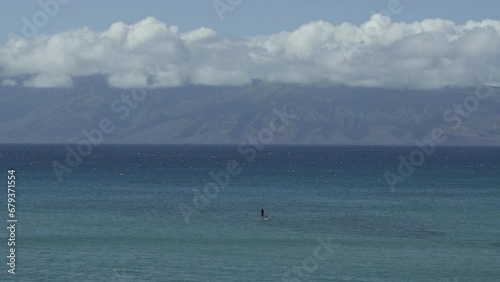 Stand up paddle surfer looking for waves Maui Molokai Hawaii (ID: 679371554)