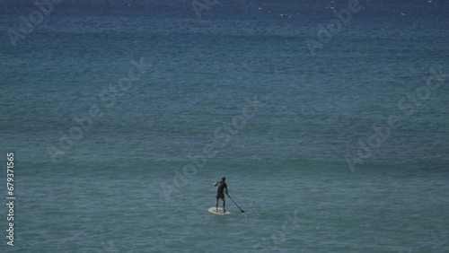 Stand up paddle surfer looking for waves Maui Hawaii (ID: 679371565)