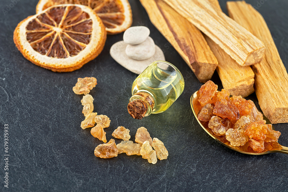 Fototapeta premium Smudge kit for spiritual practices with natural elements: Palo Santo sticks, dried orange fruit slices, SPA stones, essence and resin.