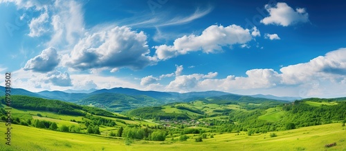 Beautiful Green hills with mountains landscape with blue sky view. AI generated