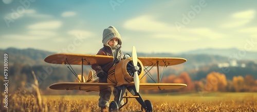 Happy girl pilot playing plane toy on field. AI generated image © orendesain99