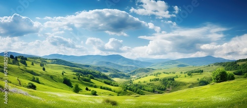 Green hills with mountains landscape with blue sky view. AI generated image