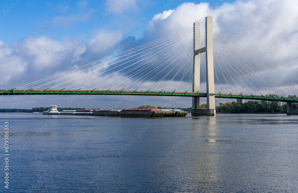 Aerial panorama of a large barge under the Great River Bridge across Mississippi between Burlington Iowa and Illinois