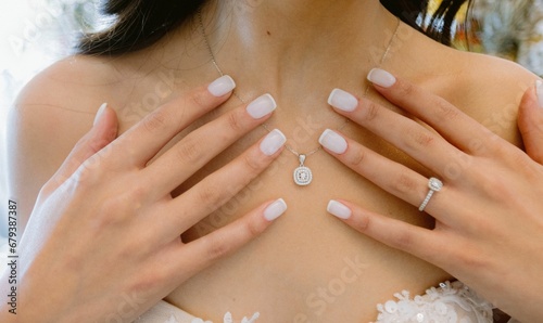 someone wearing wedding rings holding their hands to the chest of the bride