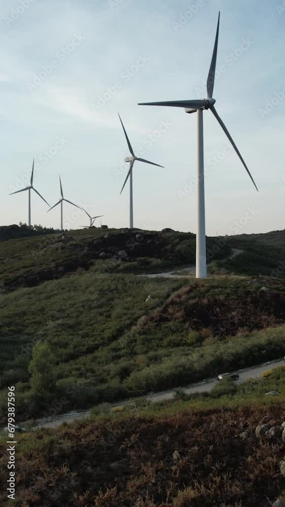 Vertical Video of Four Jeep car on the road driving towards Windmills in mountains Aerial Vertical Video of Four Jeep car on the road driving towards Windmills in mountains Aerial