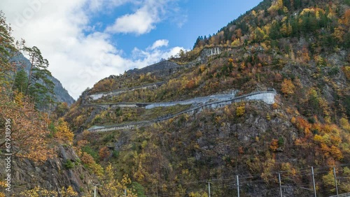 Time lapse, serpentine mountain road. Winding road in mountains. Autumn landscape. Incredible serpentine in the mountains. Silenen, Amsteg, Canton of Uri, Switzerland. photo