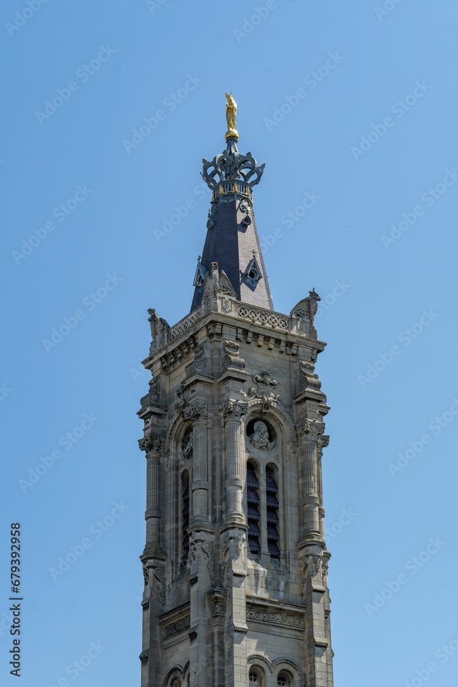 a large gray building with a clock in it's tower