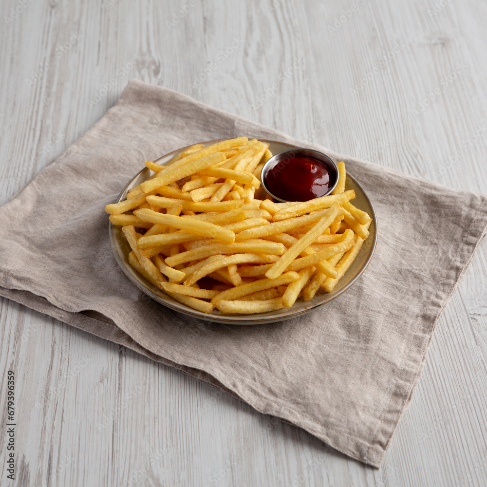 Homemade French Fries with Ketchup on a Plate, side view. Homemade French Fries with Ketchup on a Plate, side view.