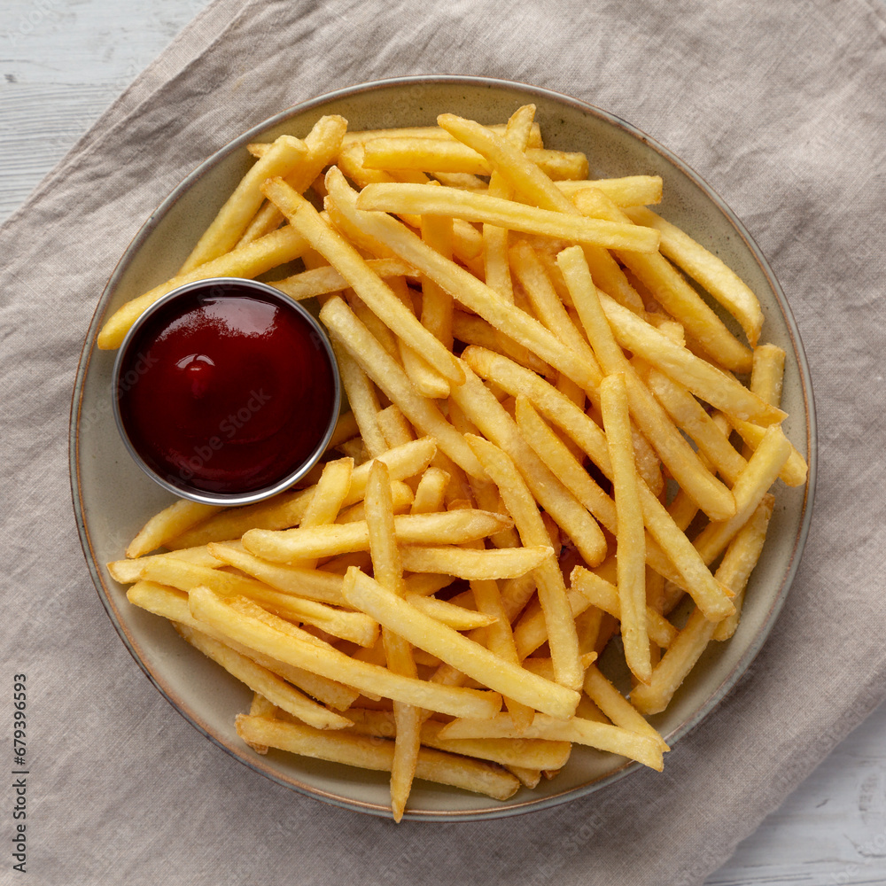 Homemade French Fries with Ketchup on a Plate, top view. Flat lay, overhead, from above. Homemade French Fries with Ketchup on a Plate, top view. Flat lay, overhead, from above.