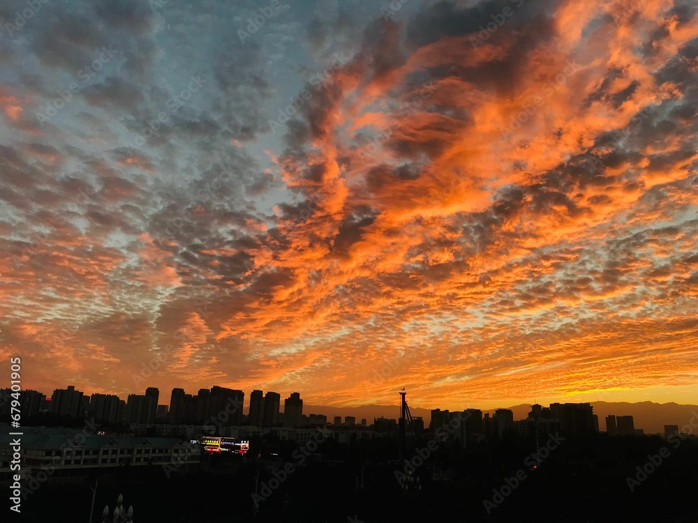 Dramatic view of a cloudy sunset sky over a sprawling cityscape