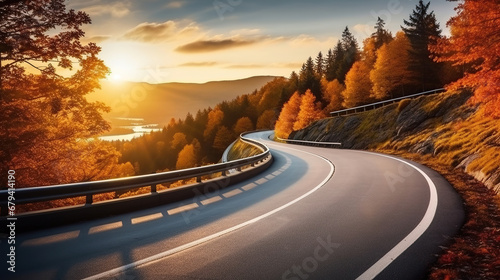Curved road on autumn, beautiful curved pass with vehicles and colorful autumn nature colors on trees with sunset light. photo