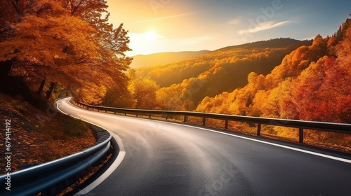 Curved road on autumn, beautiful curved pass with vehicles and colorful autumn nature colors on trees with sunset light.