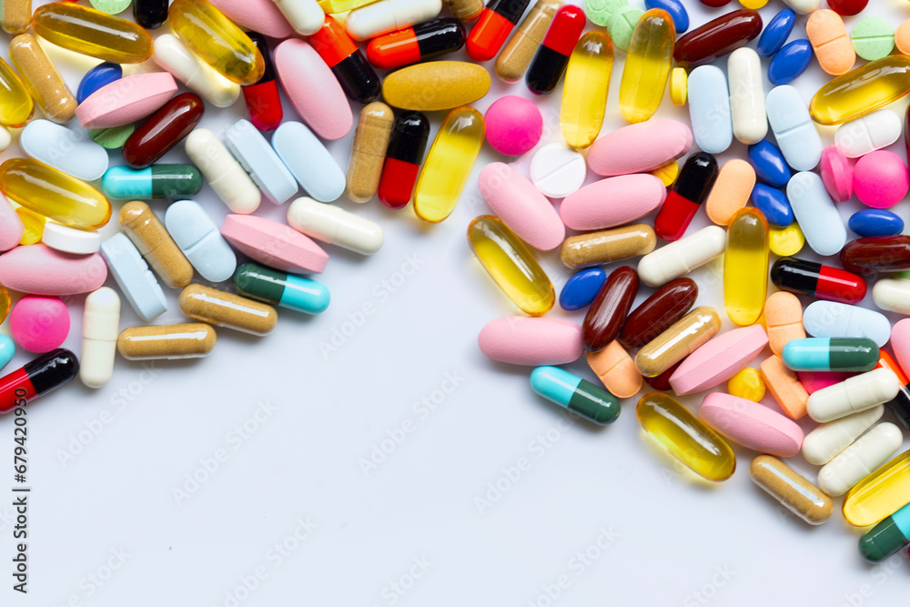 Colorful tablets with capsules and pills on white. Colorful tablets with capsules and pills on white.