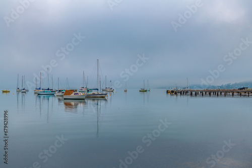 Fog, sunrise and boats on the bay © Merrillie