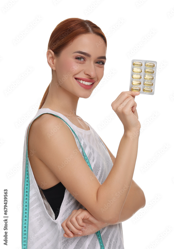 Happy young woman with pills and measuring tape on white background. Weight loss Happy young woman with pills and measuring tape on white background. Weight loss
