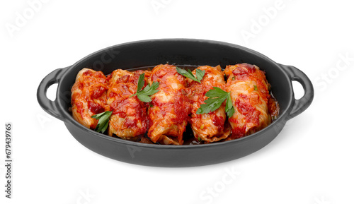 Baking dish of delicious stuffed cabbage rolls cooked with homemade tomato sauce isolated on white