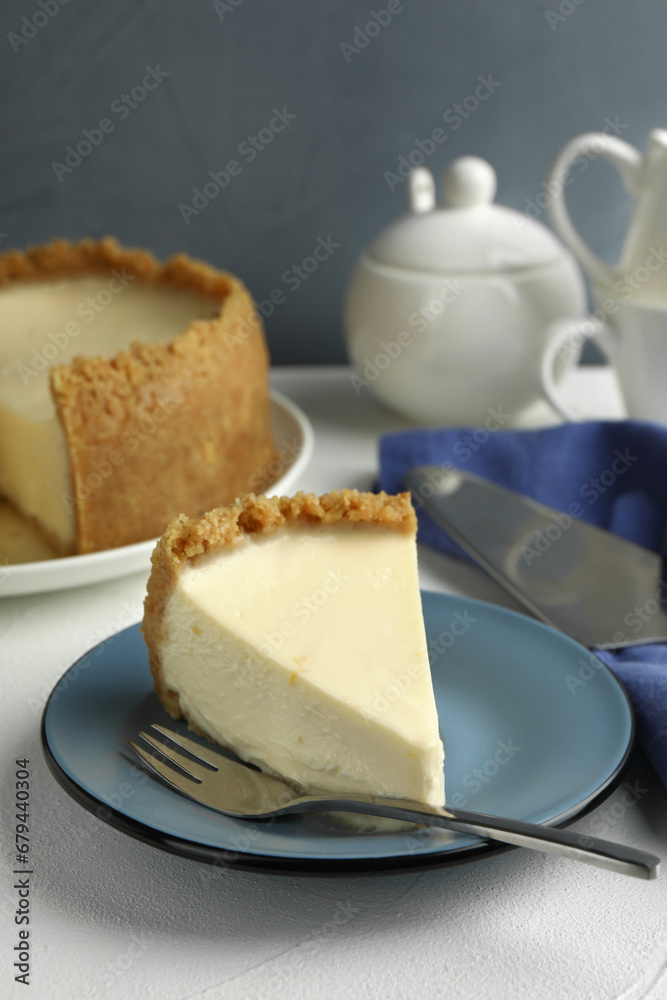 Piece of tasty vegan tofu cheesecake and fork on white table Piece of tasty vegan tofu cheesecake and fork on white table