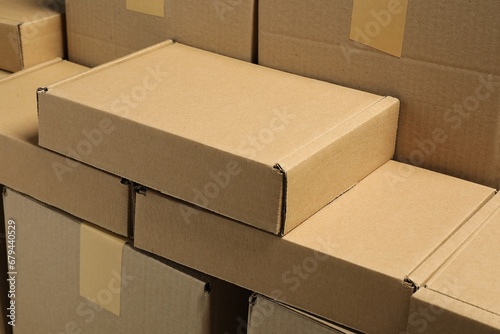 Many cardboard boxes as background, closeup. Packaging goods © New Africa