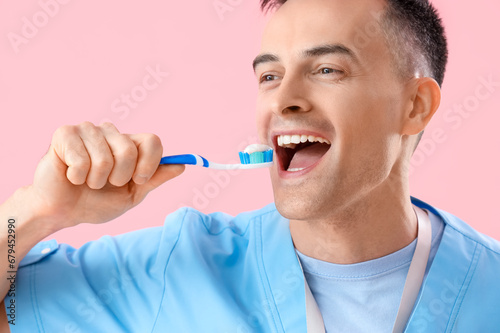 Male dentist with toothbrus...