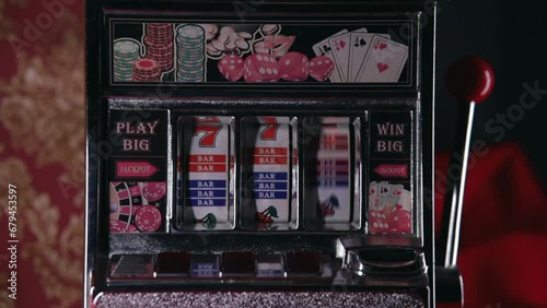Classic retro casino slot machine spinning winning jackpot closeup loop. One-armed bandit. photo