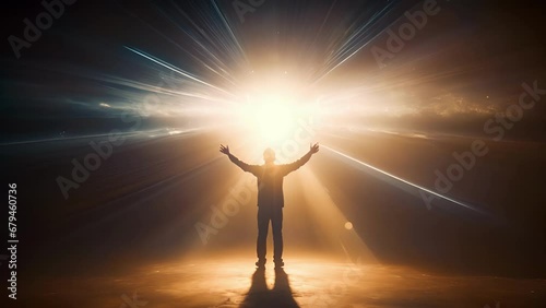 A person standing in a spotlight with their arms outstretched, surrounded by a halo of radiant light, symbolizing spiritual awakening and enlightenment. photo