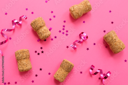 Champagne corks with Christmas decor on pink background