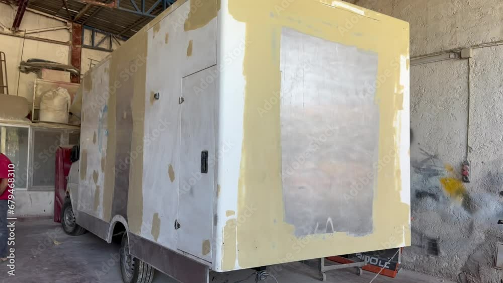 A caravan that has been puttyed, surface defects removed and prepared for painting in the industry A caravan that has been puttyed, surface defects removed and prepared for painting in the industry