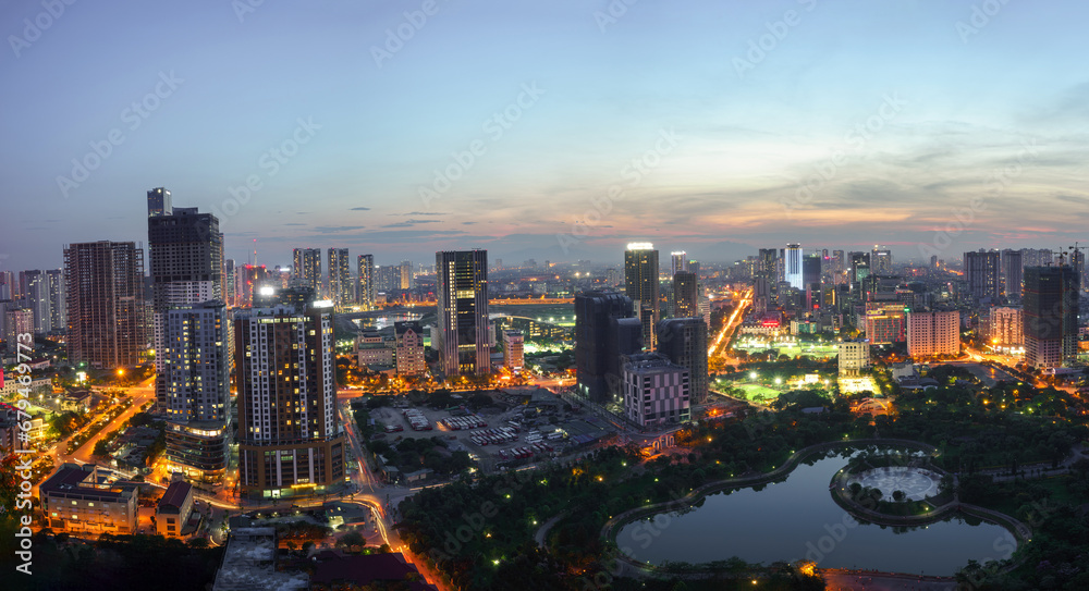Fototapeta premium Cityscape of Hanoi skyline at Cau Giay park during sunset time in Hanoi city, Vietnam