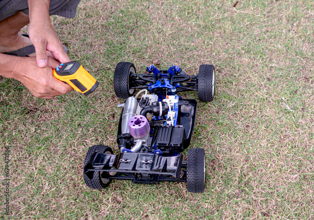 Fototapeta premium a man's hand Starting the engine, radio control race car, (RC toys)