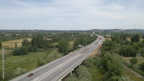 Aerial view of the A1 in Coimbra portugal, this is the most important highway in portugal as it connects Lisbon to Porto. Drone moving forward showing some cars and lorry’s travelling.