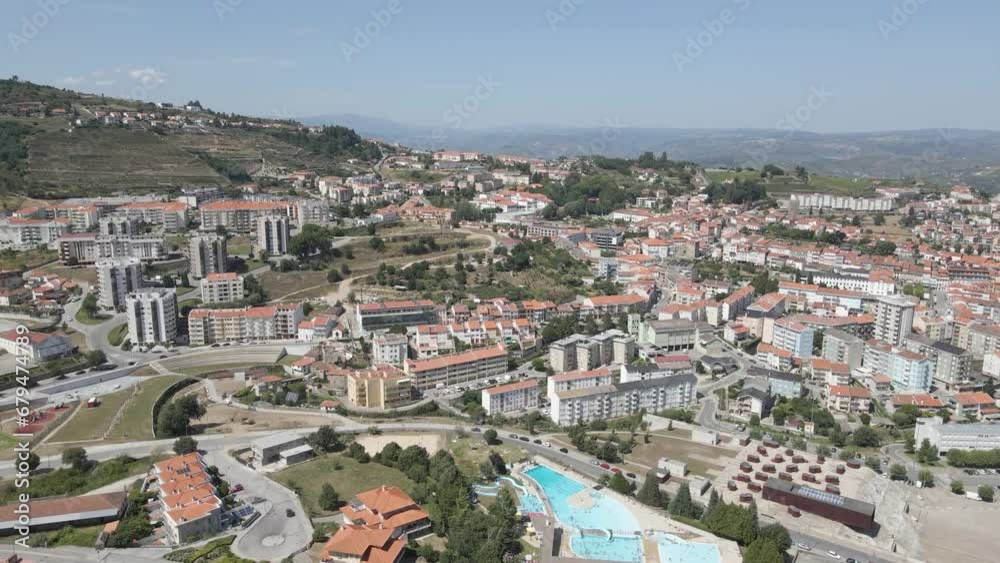 Aerial view of Lamego city rooftops. Drone moving forward showing the blue sky on the background.
Aerial view of Lamego city rooftops. Drone moving forward showing the blue sky on the background.