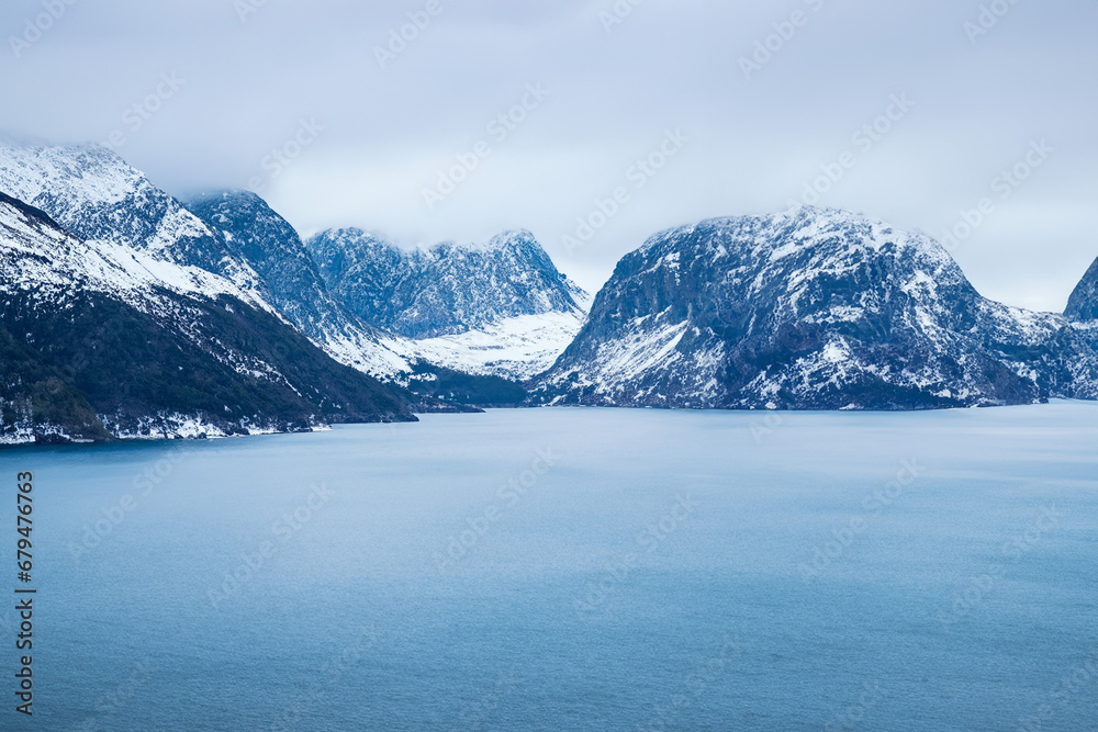 Norwegian fjord landscape in winter. Mountains and sea.